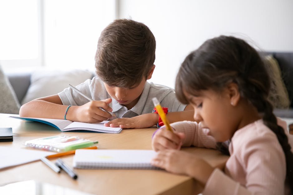 Two children studying together at home, focused on their schoolwork.