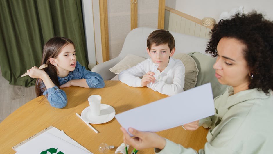 A teacher and children engaging in learning activities at a round table indoors.