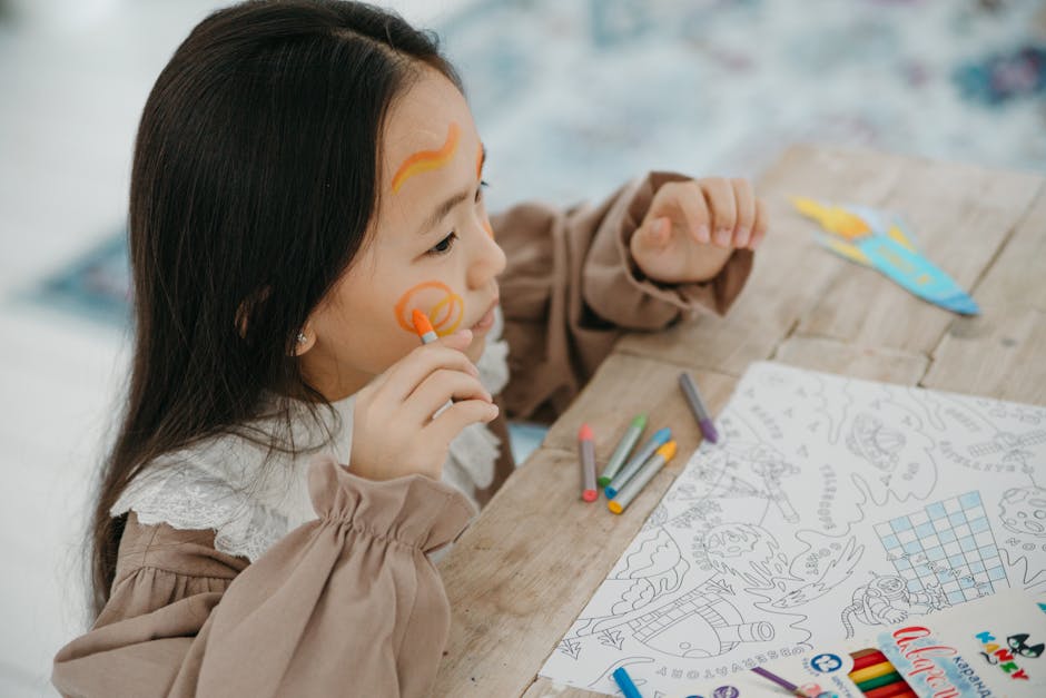 Young girl having fun with face painting and drawing, expressing creativity and joy.
